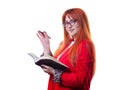 Beautiful female student in glasses in red business suit with notebook in hand Royalty Free Stock Photo