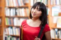 Beautiful female student in a library Royalty Free Stock Photo