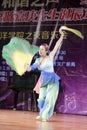 Beautiful female student perform folding fan dance