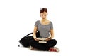 Beautiful female student sitting on floor studying Royalty Free Stock Photo