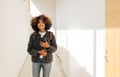 Beautiful female student walking through college hallway. Girl going for the class and smiling Royalty Free Stock Photo