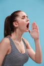 The young woman is calling on the blue background.