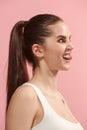 The young woman is looking crazy on the pink background. Royalty Free Stock Photo