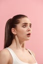 The young woman is looking surprising on the pink background. Royalty Free Stock Photo