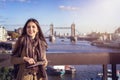 A beautiful female tourist in London holding a travel guide