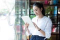 Beautiful female using digital tablet in cafe Royalty Free Stock Photo