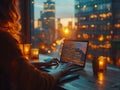 Beautiful Female Using Laptop Computer, beautiful view of the evening city in the background Royalty Free Stock Photo