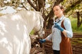 beautiful female vet inspects a white horse. Love, medicine, pet care, trust, happiness, health. A girl vaccinates a