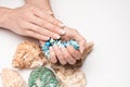 Beautiful Female well-groomed Hands with French manicure holding sea shell over light background Royalty Free Stock Photo