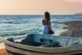 Beautiful female in the pareo near boat on the sand Royalty Free Stock Photo