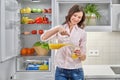 Beautiful female pouring fresh orange juice in glass Royalty Free Stock Photo