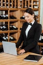 beautiful female wine steward working with laptop