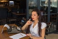 Female writer with vintage typewriter making notes in a coffee s Royalty Free Stock Photo