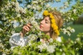 Beautiful feminime woman in national dress with white spring flowers