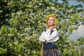 Beautiful feminime woman in national dress with white spring flowers