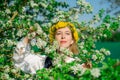 Beautiful feminime woman in national dress with white spring flowers