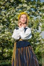 Beautiful feminime woman in national dress with white spring flowers