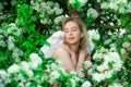 Beautiful feminime woman with white wings with white spring flowers.