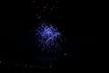 A beautiful festive background with bright blue fireworks lighting up the black night sky outside Royalty Free Stock Photo