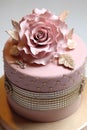 Beautiful festive cake with a rose made of white chocolate on top.