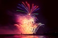 Beautiful, festive, colorful fireworks over the sea with reflection Royalty Free Stock Photo