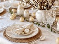 Beautiful festive table setting with colorful Easter eggs and decorative dishes and flowers Royalty Free Stock Photo