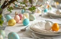 Beautiful festive table setting with colorful Easter eggs and decorative dishes and flowers Royalty Free Stock Photo