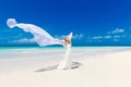 beautiful fiancee in white wedding dress and big long white train, stand on shore sea