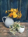 Beautiful field flowers in cups wooden backdrop Royalty Free Stock Photo