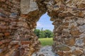 Beautiful field view and the ancient window of an old ruined castle Royalty Free Stock Photo