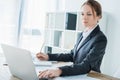 beautiful financier using laptop at table