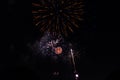 Multiple Fireworks in night sky in a composition in shades red and gold Royalty Free Stock Photo