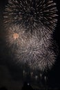 Multiple Fireworks in night sky in a composition in shades white and gold