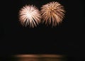 Beautiful fireworks display on evening black sky. Ingolden color holiday background with copy space Royalty Free Stock Photo