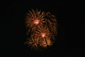 Beautiful fireworks display on evening black sky. In red and golden color holiday background with copy space Royalty Free Stock Photo