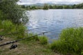 Fish pond near Badin, Banska Bystrica, Slovakia. Fishing place. Fish pond in summer day. Fishing rods. Waiting for fish