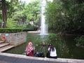 Beautiful fish pond with tall fountain in Kowloon park, Hong Kong