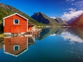 Beautiful fishing house on fjord. Beautiful nature with blue sky, reflection in water and fishing house. Norway Royalty Free Stock Photo