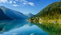 Beautiful fishing houses on fjord. Beautiful nature with blue sky, reflection in water and fishing house. Norway Royalty Free Stock Photo