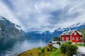 Beautiful fishing house on fjord. Beautiful nature with blue sky, reflection in water and fishing house. Norway Royalty Free Stock Photo