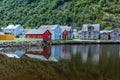 Beautiful fishing village on fjord. Beautiful nature with reflection in water, rocky beach and fishing house. Norway Royalty Free Stock Photo