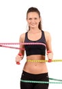 Beautiful fit girl with measuring tape around her bust, waist and hips holding dumbbells. Royalty Free Stock Photo