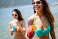 Beautiful fit girls in summer day having fun and cocktails on beach Royalty Free Stock Photo