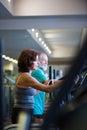 Beautiful fit senior couple in gym doing cardio work out. Royalty Free Stock Photo