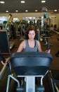 Beautiful fit senior woman in gym doing cardio work out. Royalty Free Stock Photo