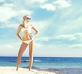 Beautiful, fit and girl in white bikini posing on a beach a Royalty Free Stock Photo