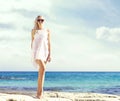 Beautiful, fit and girl in white bikini posing on a beach Royalty Free Stock Photo