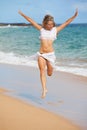 Beautiful Fit Woman Jumping at the Beach Royalty Free Stock Photo