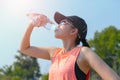 Beautiful fitness athlete woman drinking water after work out exercising on. evening summer Royalty Free Stock Photo