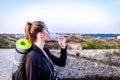 A tourist girl drinks water in bright sunlight Royalty Free Stock Photo